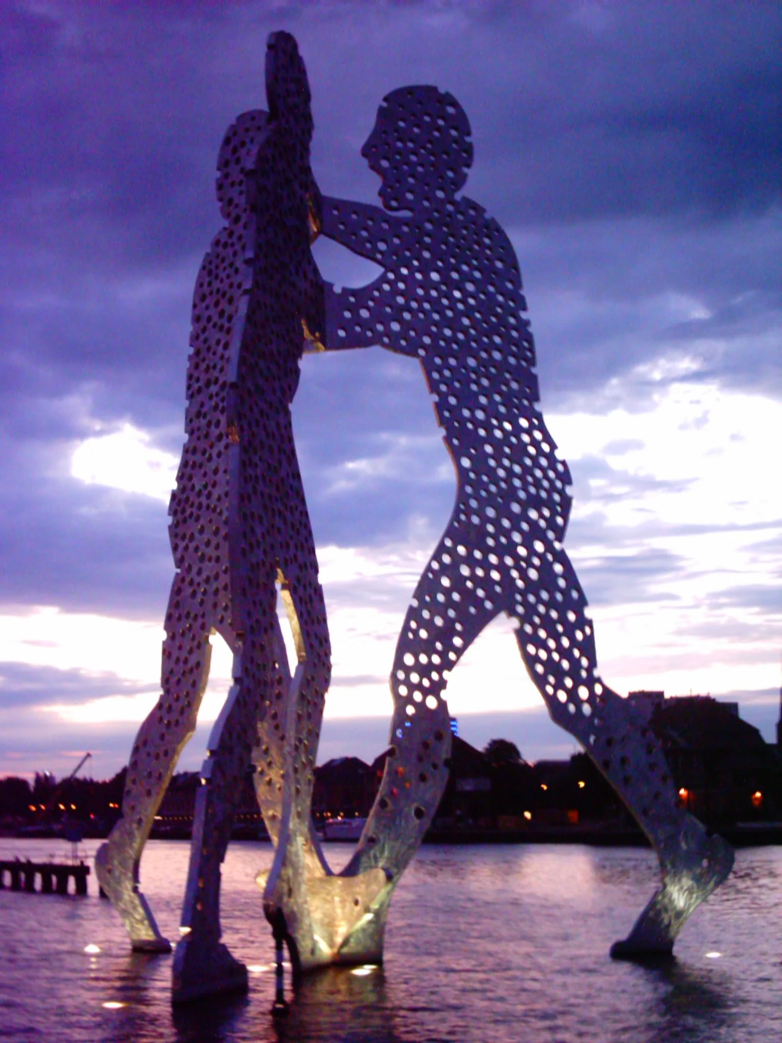  Molecule Man 1+1+1 - a sculpture by Jonathan Borofsky in Berlin, Germany, of three aluminium figures, which unite to form a whole, meant by the artist to remind the viewer ‘that finding wholeness and unity within this world remains the aim of any creative and spiritual tradition’.  PHOTO:  Jensen, Wikimedia Commons . 