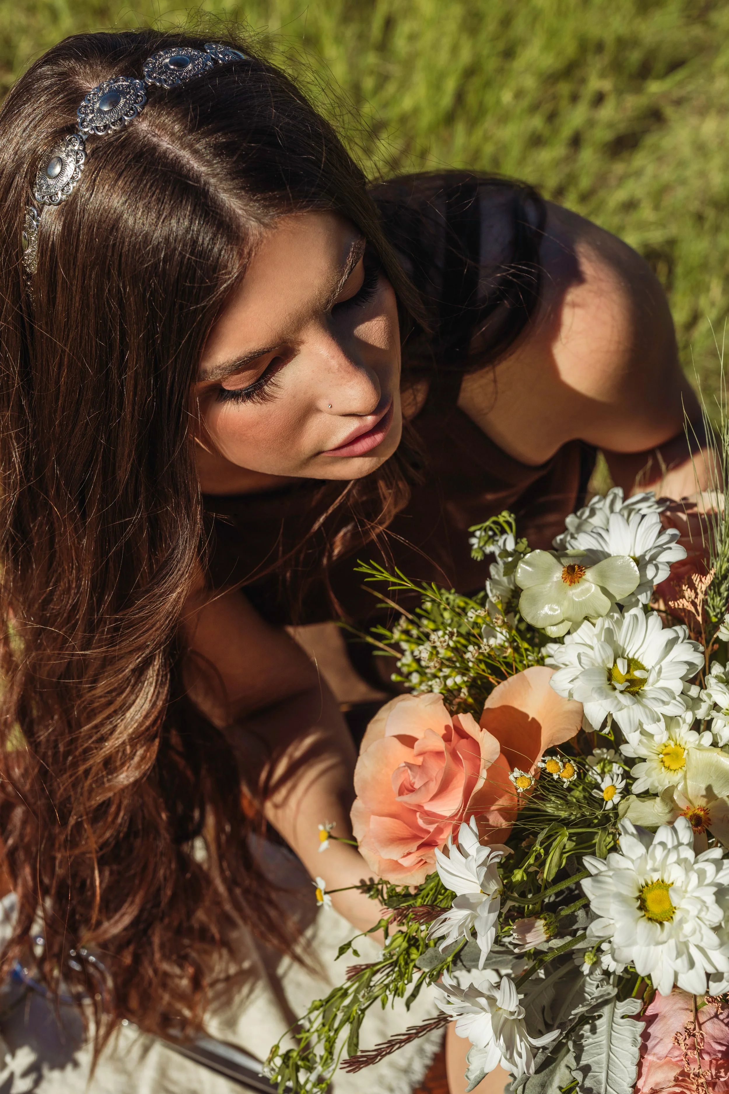 Woman holding wildflowers in warm sunset light for Tru Western Amber Waves campaign.