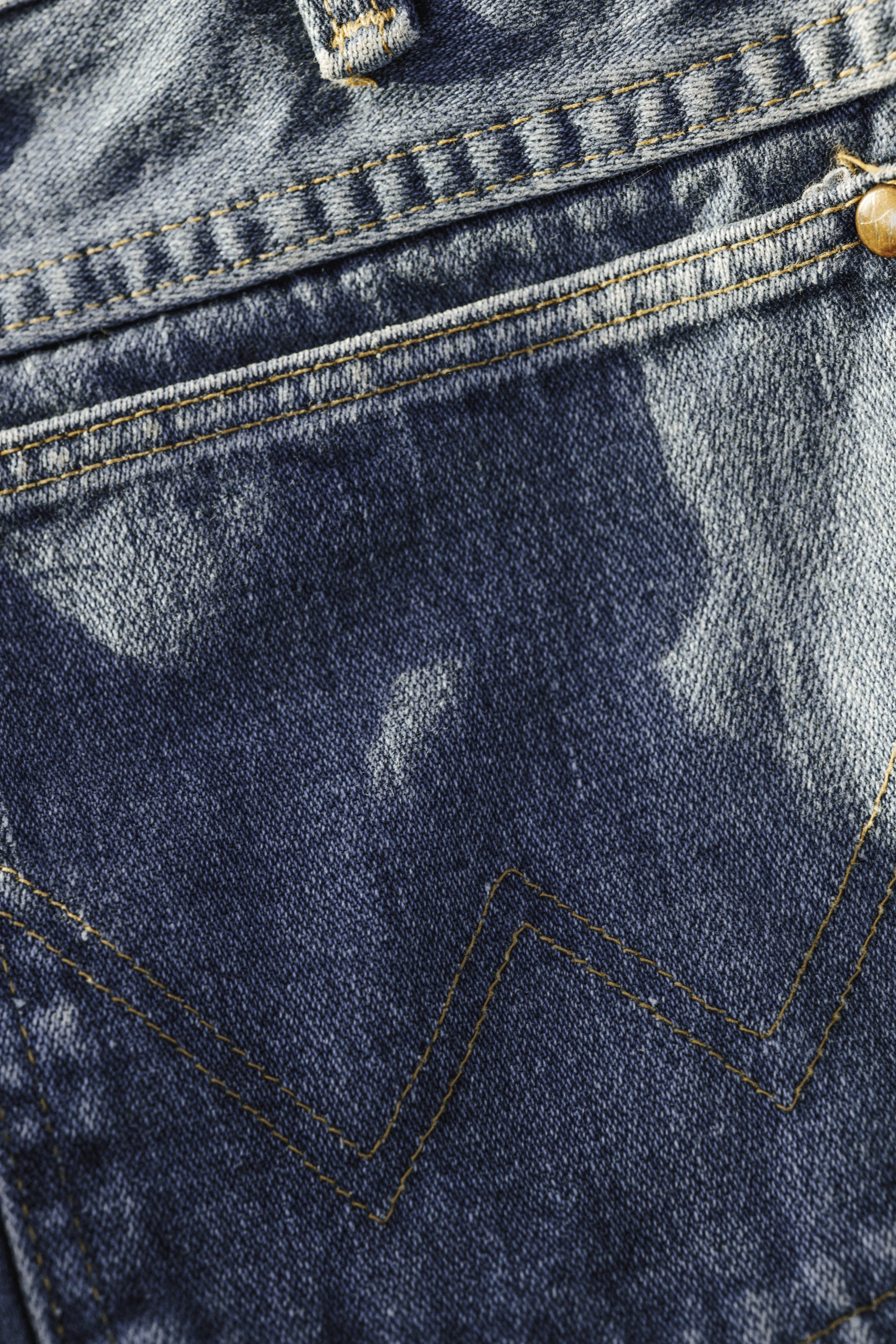 Wrangler denim detail photography highlighting Western stitching texture for Wrangler Original fragrance