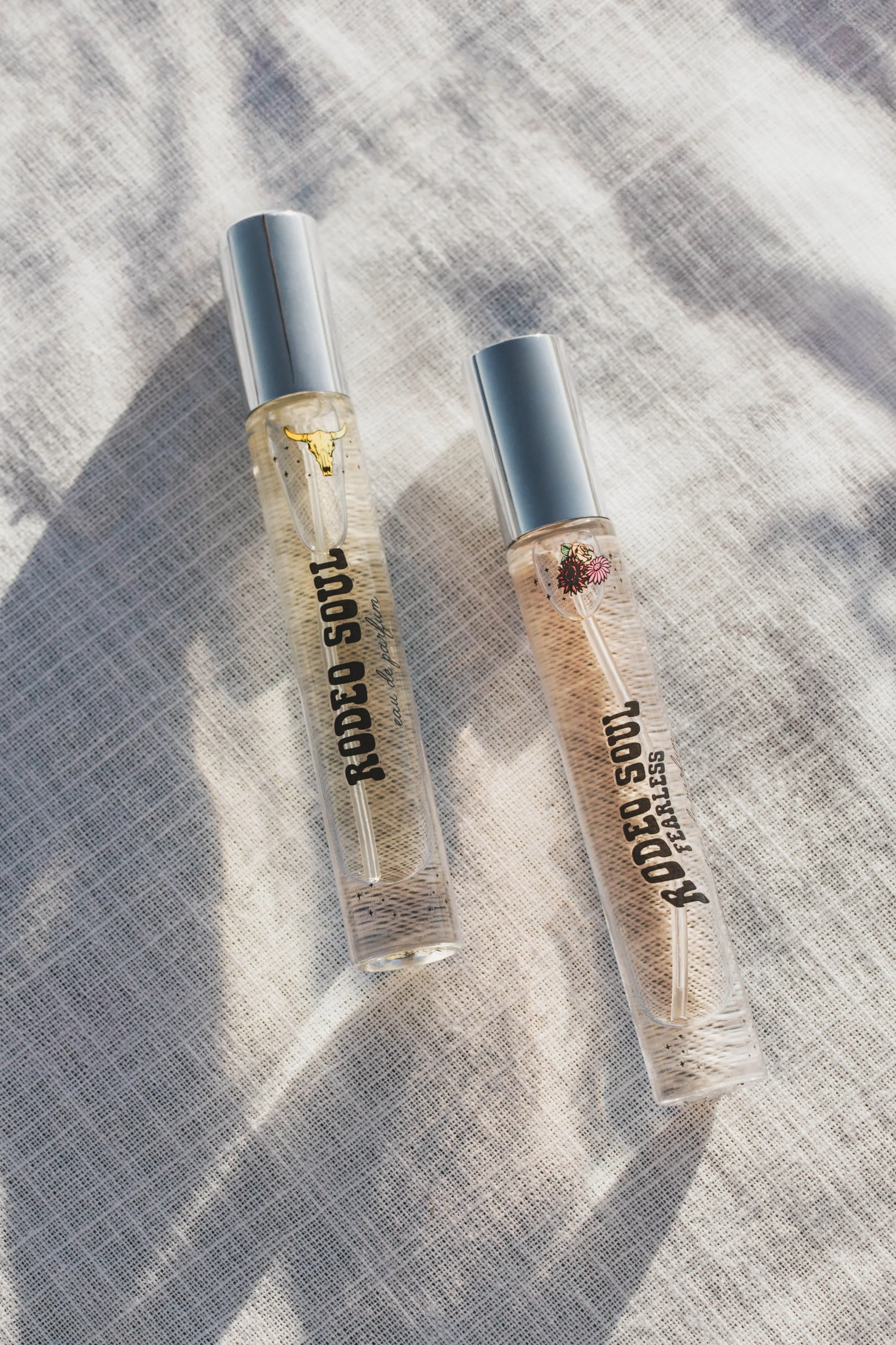 Tru Western Rodeo Soul and Rodeo Soul Fearless purse spray fragrances styled on neutral linen fabric in natural light.
