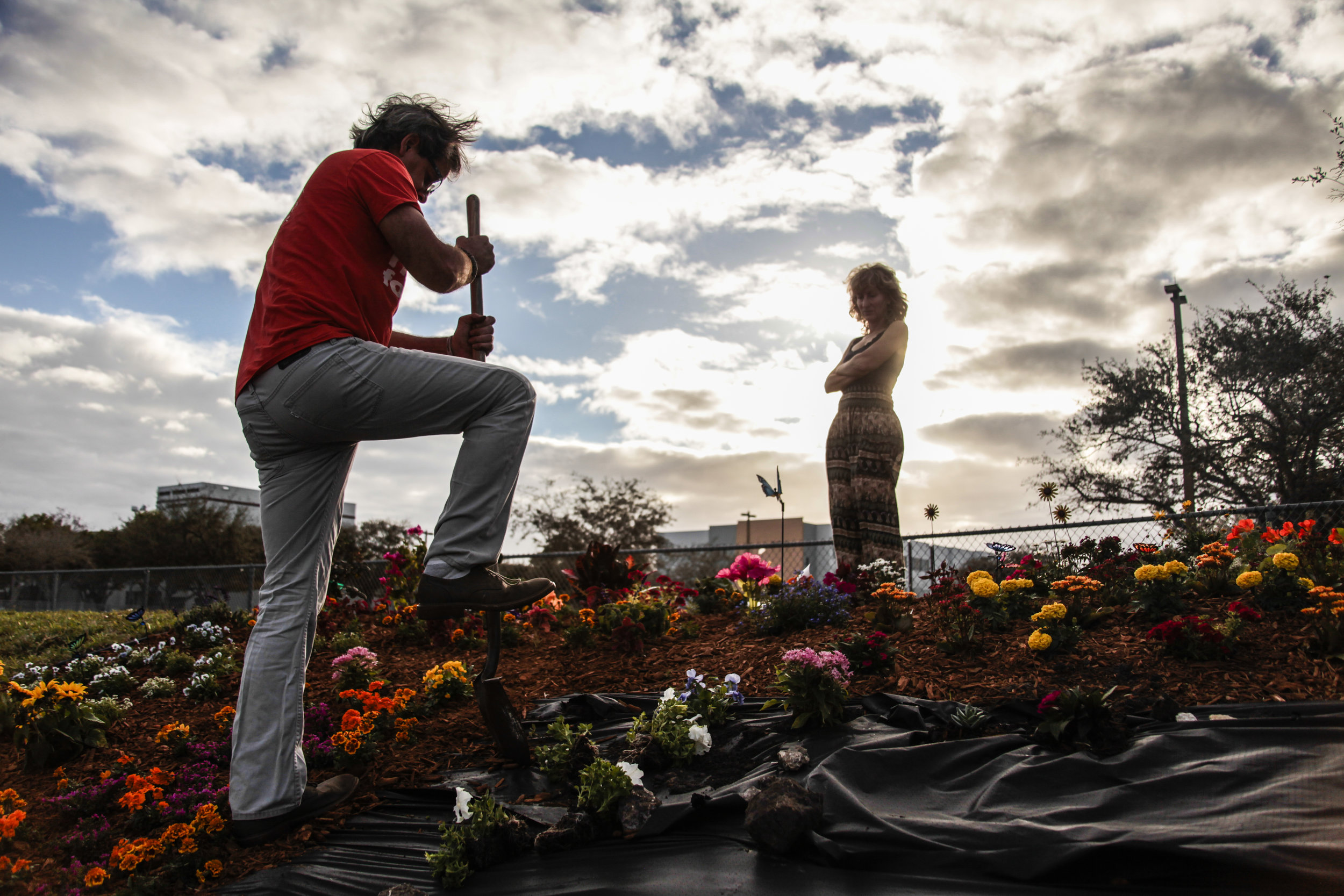 In Parkland, Fla., Eric Edwards planted flowers in front of Marjory Stoneman Douglas High School, February 14, 2019, marking the year where two of his children survived a mass shooting, though both have struggled with trauma from the event.