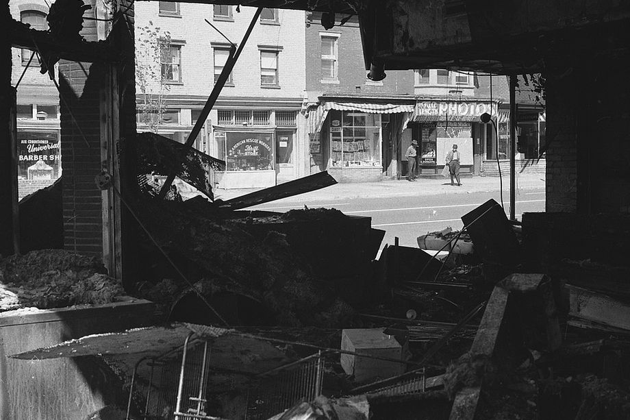  Damage to a storefront after the riots   via   