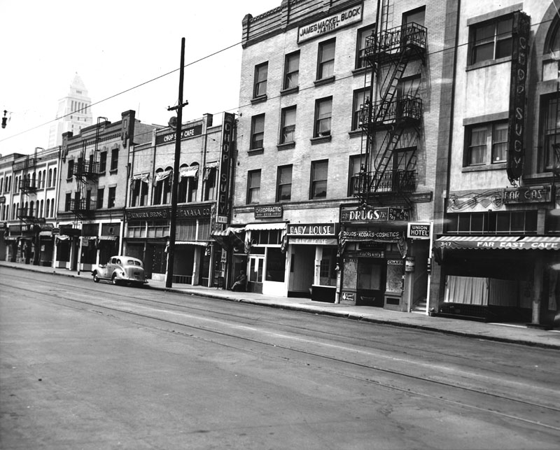  A deserted E. First Street in 1942, after the forced removal of Japanese Americans. The Mikado is the second building from the left  via  