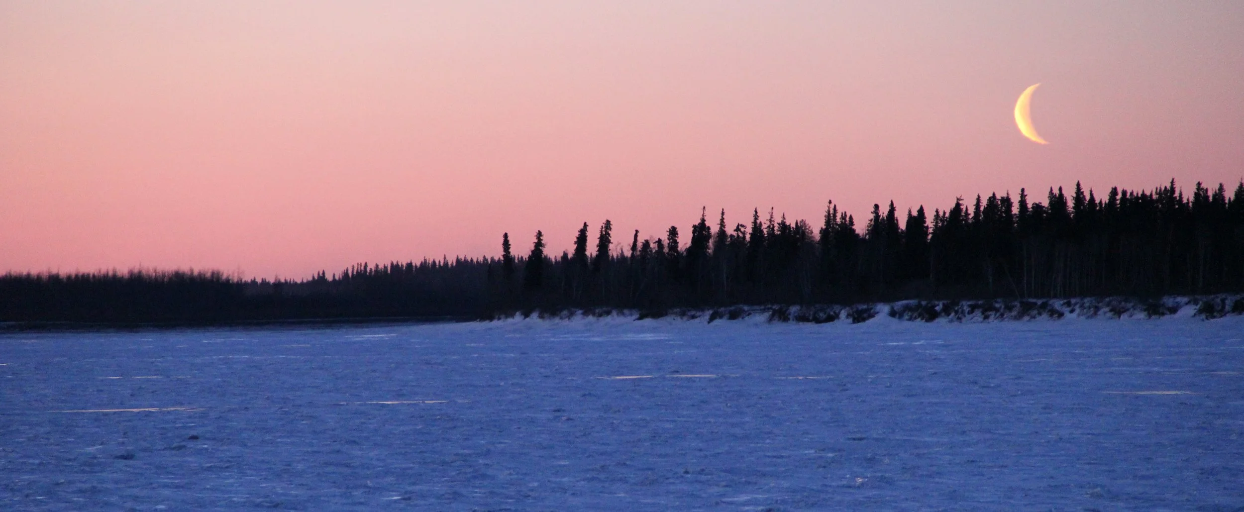 The moon going down on the far side of the Frozen Yukon