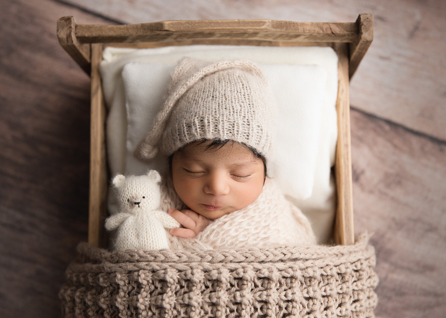  neutral cream bed prop set up with newborn baby boy in wool sleepy hat sleeping in Winnipeg with Sue Skrabek Photography 