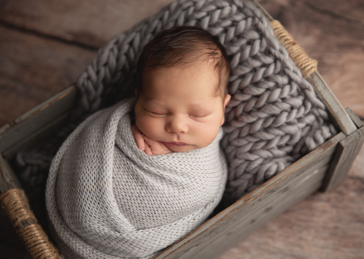  Newborn baby boy in grey wrap crate pose with Sue Skrabek Photography in Winnipeg 