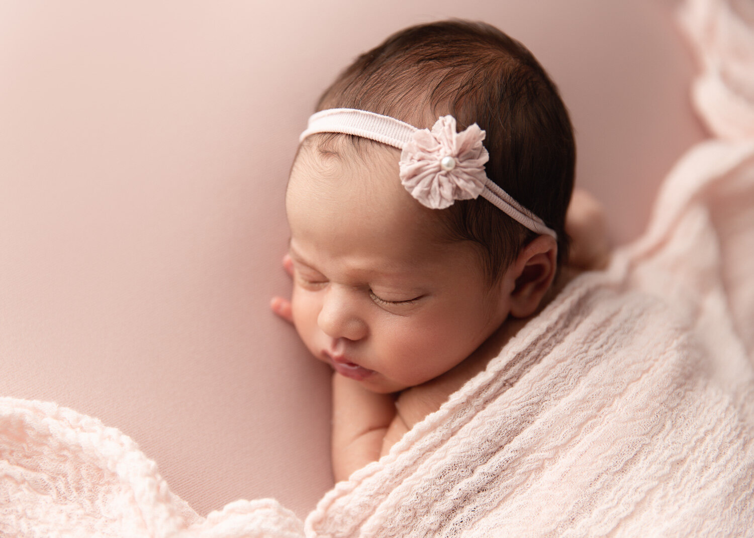 Gorgeous classic newborn girl posed with soft pink blanket and simple headband in Winnipeg 