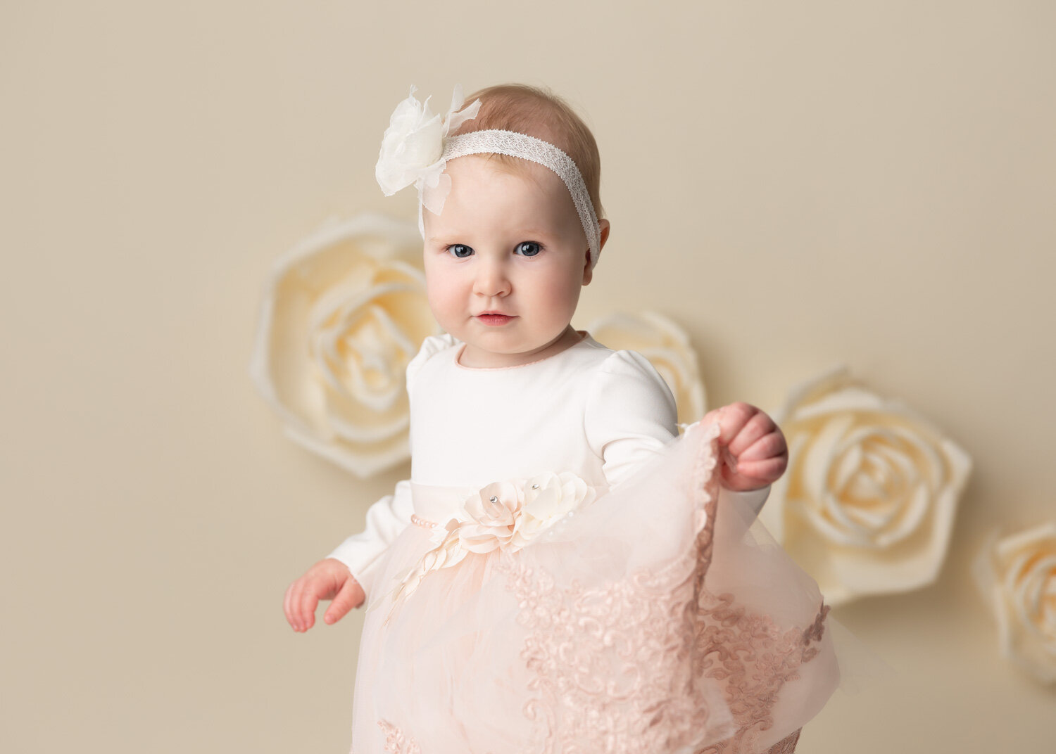  Beautiful one year old girl playing with pink tule dress during milestone photography shoot in Winnipeg 