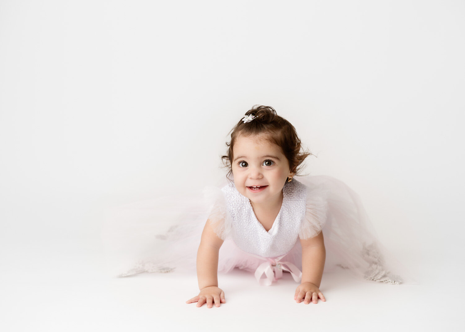  Beautiful young baby girl in pink tutu crawling for child photography session in Winnipeg 