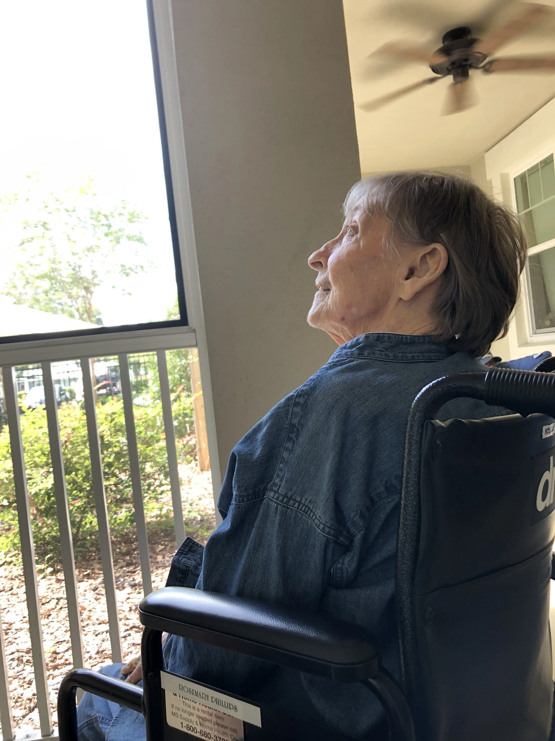My mom enjoying some time on the porch at her memory care home—photo by TK