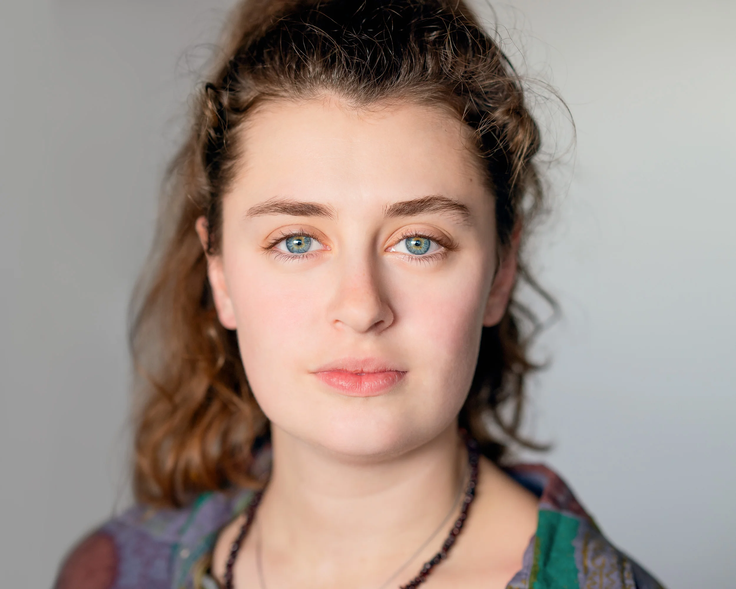 Front on, the light is even across the face. Shadows appear to shape the cheeks and chin. This is the most flattering light for people, as it reduces contrast and the perception of facial imperfections.
