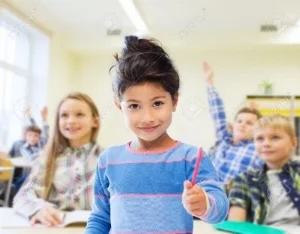 36288086-education-elementary-school-and-children-concept-happy-little-student-with-pen-girl-over-classroom-a-Stock-Photo.jpg