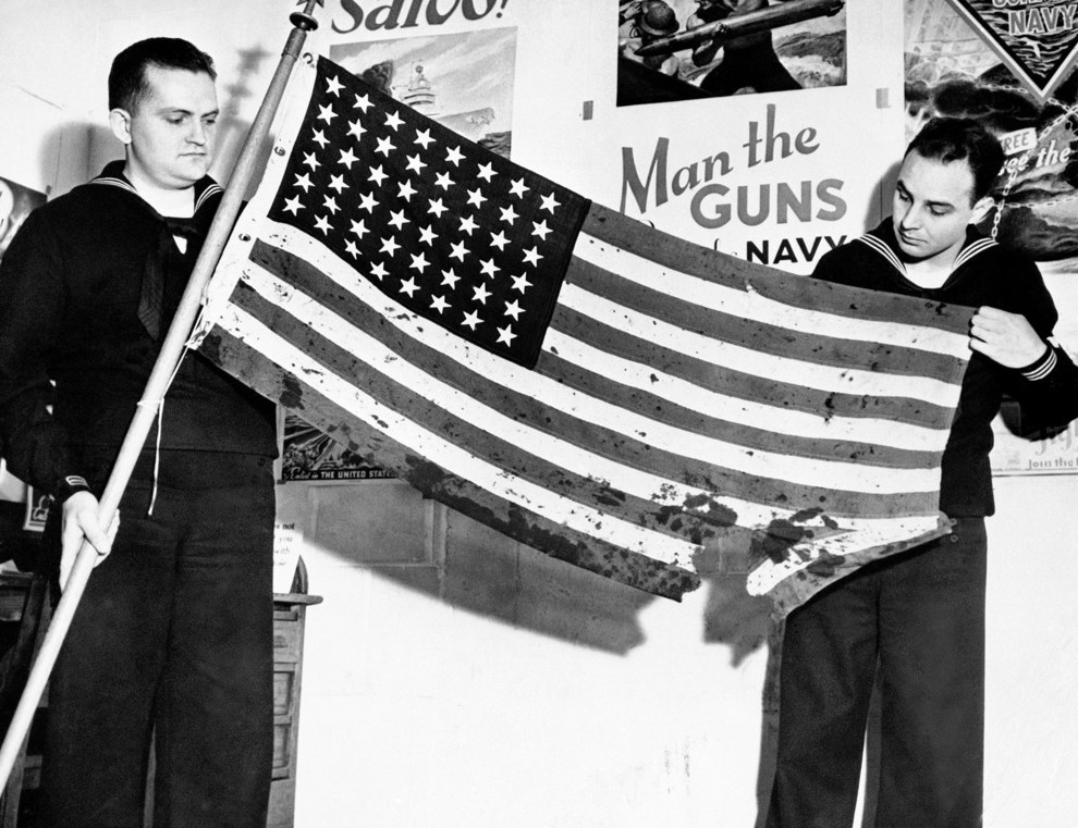 This oil stained, battle torn American flag was flying proudly from a ship in Pearl Harbor when the Japanese struck..jpg