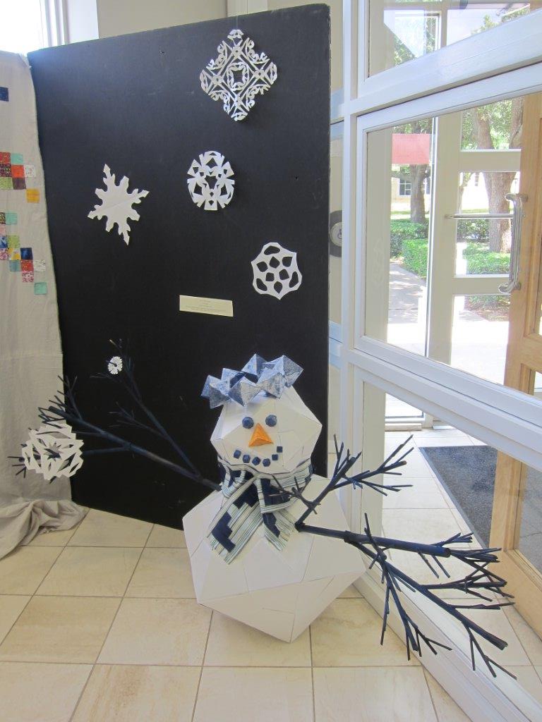 Platonic solid snowman with fractal arms and frieze patterned scarf and n-fold symmetry snowflakes