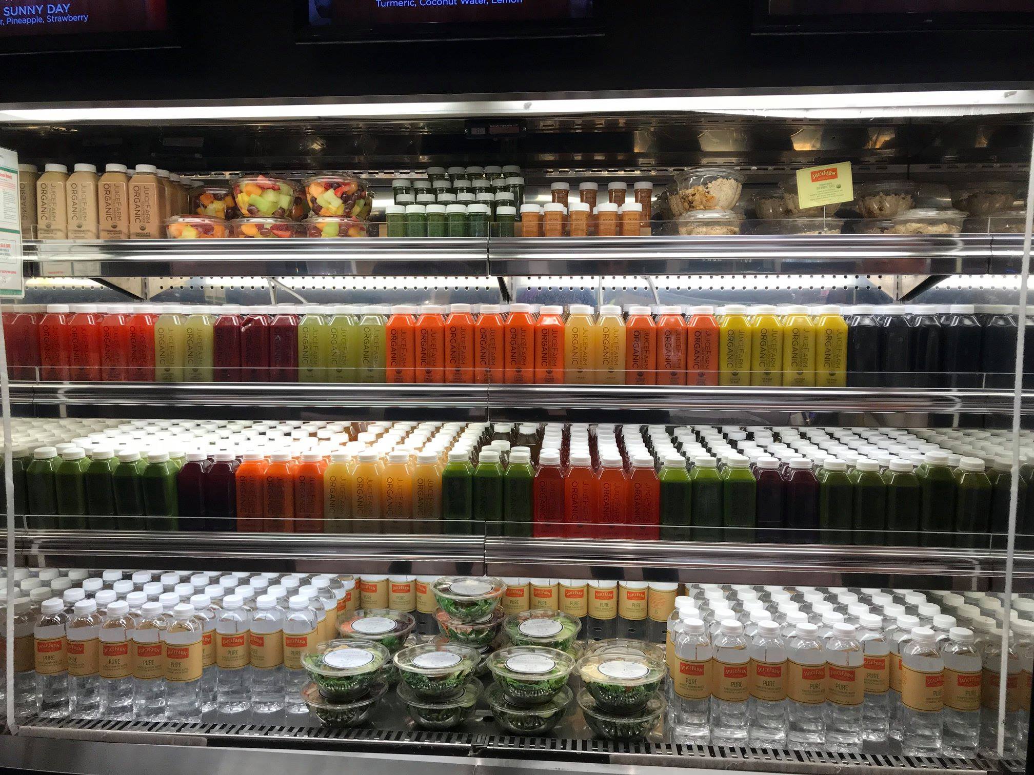 A fridge full of juices and salads