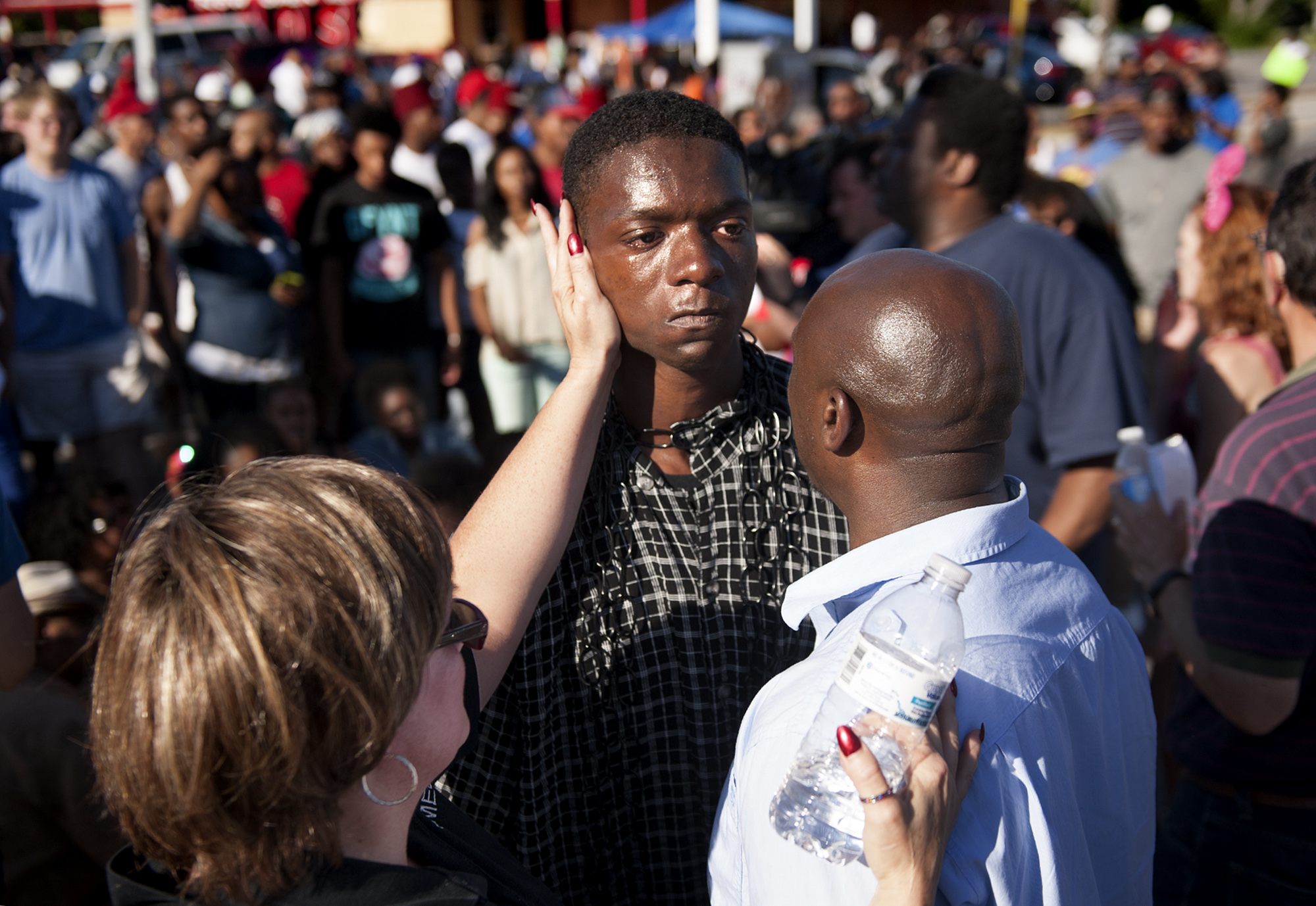 The Rev. Willis Johnson (right) confronts 18-year-old Joshua Wilson as protesters defy police and block traffic on West Florissant Avenue at Canfield Drive in Ferguson, Mo. Wednesday, Aug. 13, 2014 as part of their protests over the the shooting of …