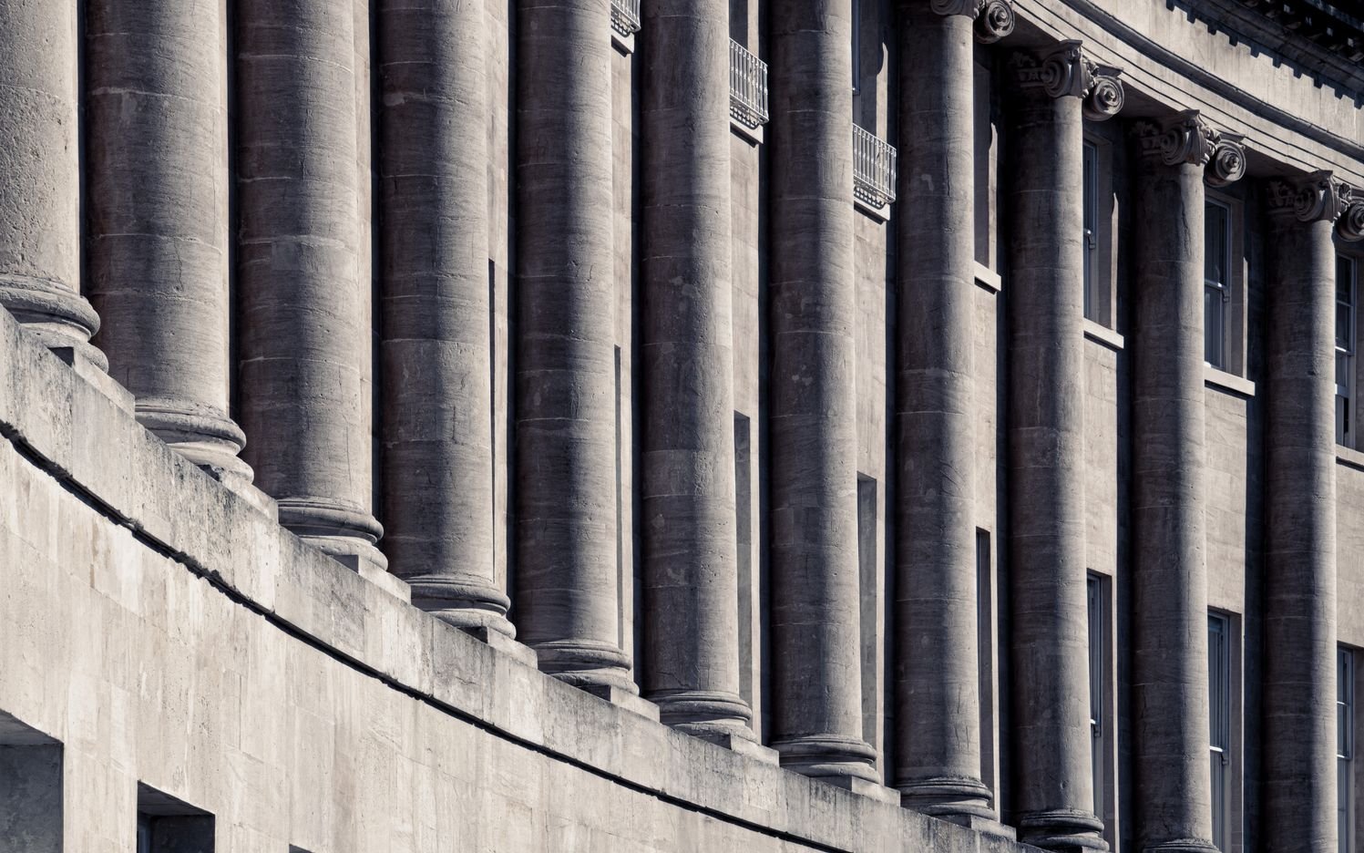 Photograph of the colonnaded façade of The Royal Crescent, Bath, England.  Symmetry, shadow and light define this architectural image.