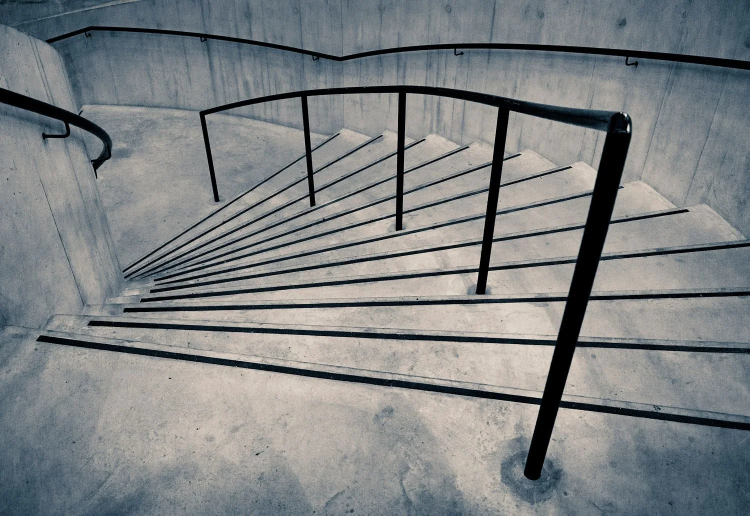 Staircase in the extension to the Tate Modern. Image comprises lines formed by the stair nosings and the central steel barrier.