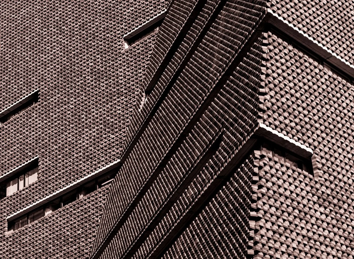 The brick façade of the extension to Tate Modern, London. Angles and shadows define this photograph highlighting the architecture of the building.