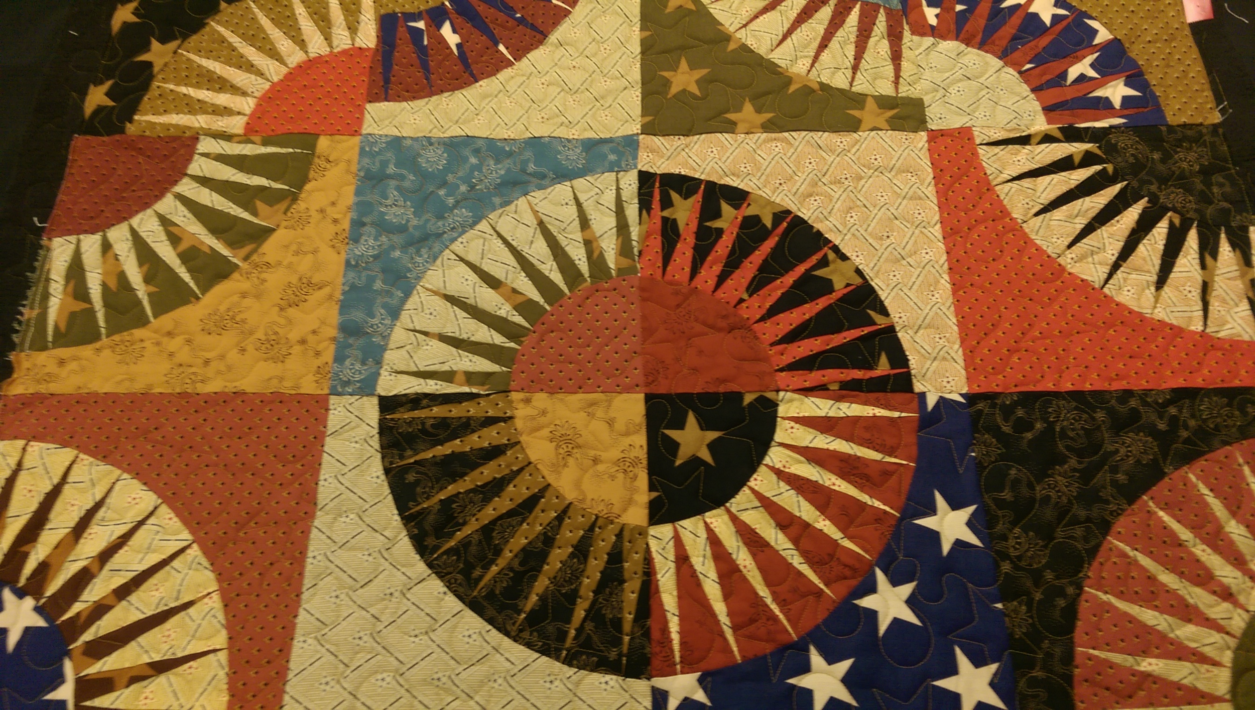 What do I do during a two day Nebraska ice storm? I quilt , of course and what a pleasure to quilt this piece from a customer. Her paper piecing was excellent and I love the colors she chose. 