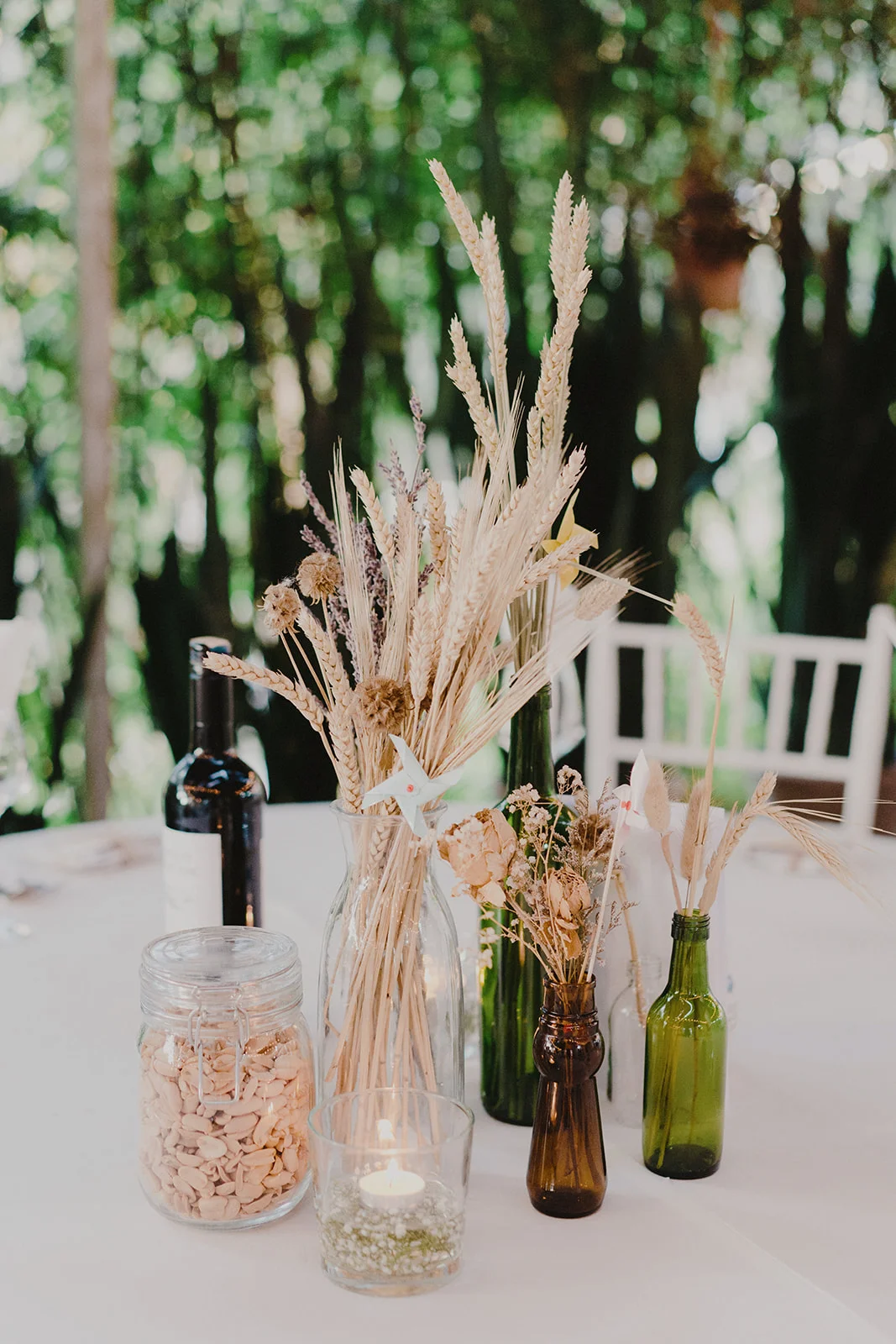 i have a huge collection of glass jars over the years (couldn’t help but to keep all of it) and the jars became super useful for our table centerpieces. we filled them up with some dried flowers, nuts, tealight candles..