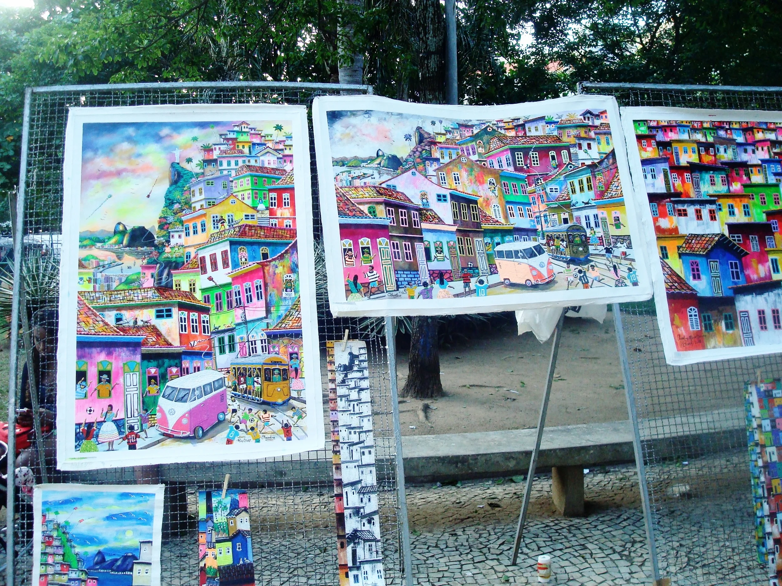 Bold, bright colors are used in paintings to depict the streets of the Favelas neighborhoods. A reminder that our mood can be altered through the right mindset, even in situations of hardship. 