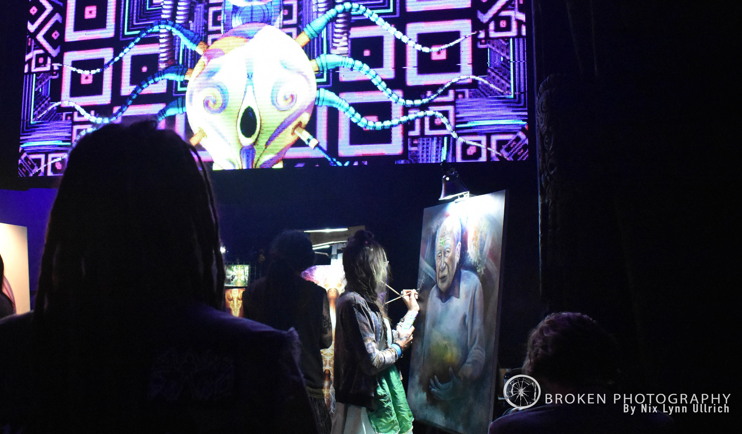 Venue Goers admiring the live artists paint.