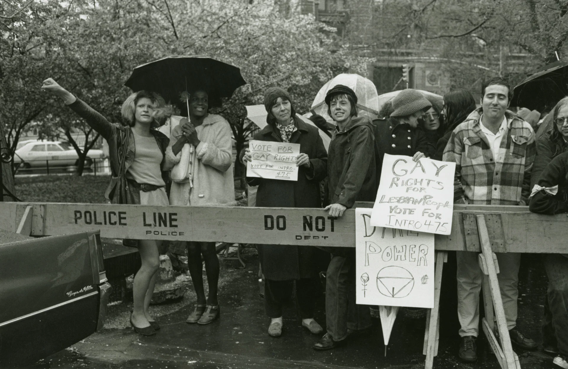 Marsha P. Johnson holds an umbrella as she and Sylvia Rivera march for Pride.