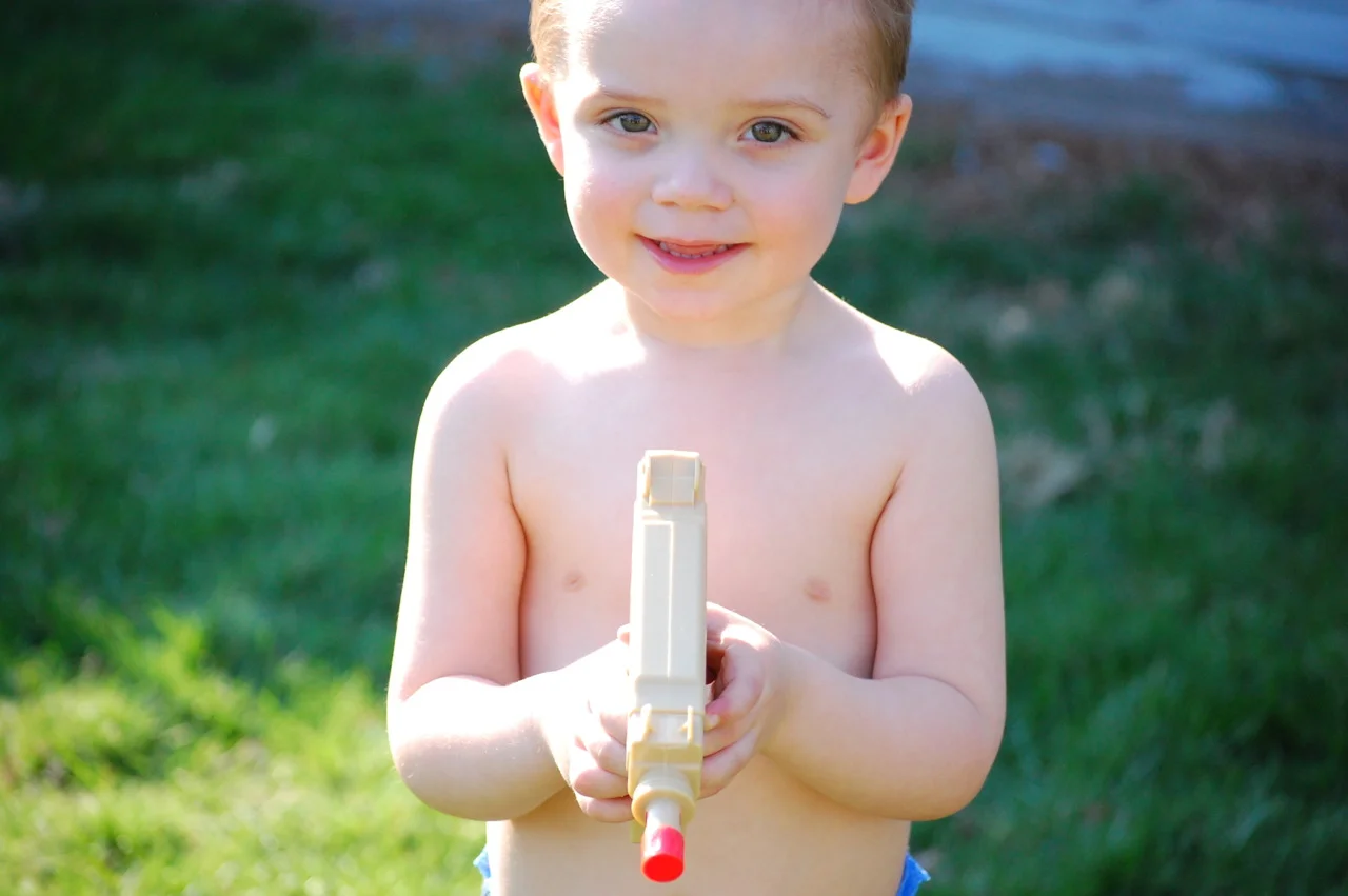 Had a photoshoot yesterday at this kid’s dad’s house DEEEEP in the south side. We were there because pops has more tactical firearms than you do on Black Ops, and we were using them as props. The kid came out with his own Uzi so I snapped this. Fitting, and the picture looks pretty ok too.