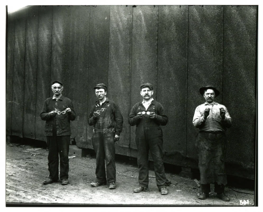 1910 - Showing off new safety goggles.