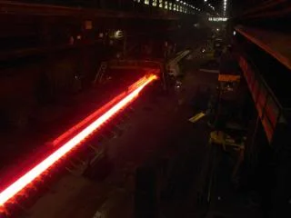  "Hot strip coming from the 4 high roughing mill down to first the 'crop shear' (it is a flying shear that 'crops' cuts the front and back couple feet off the strip) the actual cut is like this ) then it feeds into #1 finish mill stand."