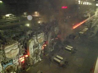 "Hot strip coming out of #6 finish mill heading to the Coiler. Notice the pollution that I breathed for 23 years."