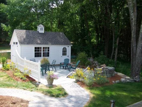 Paver garden paths, custom stone fireplace, fence and patio