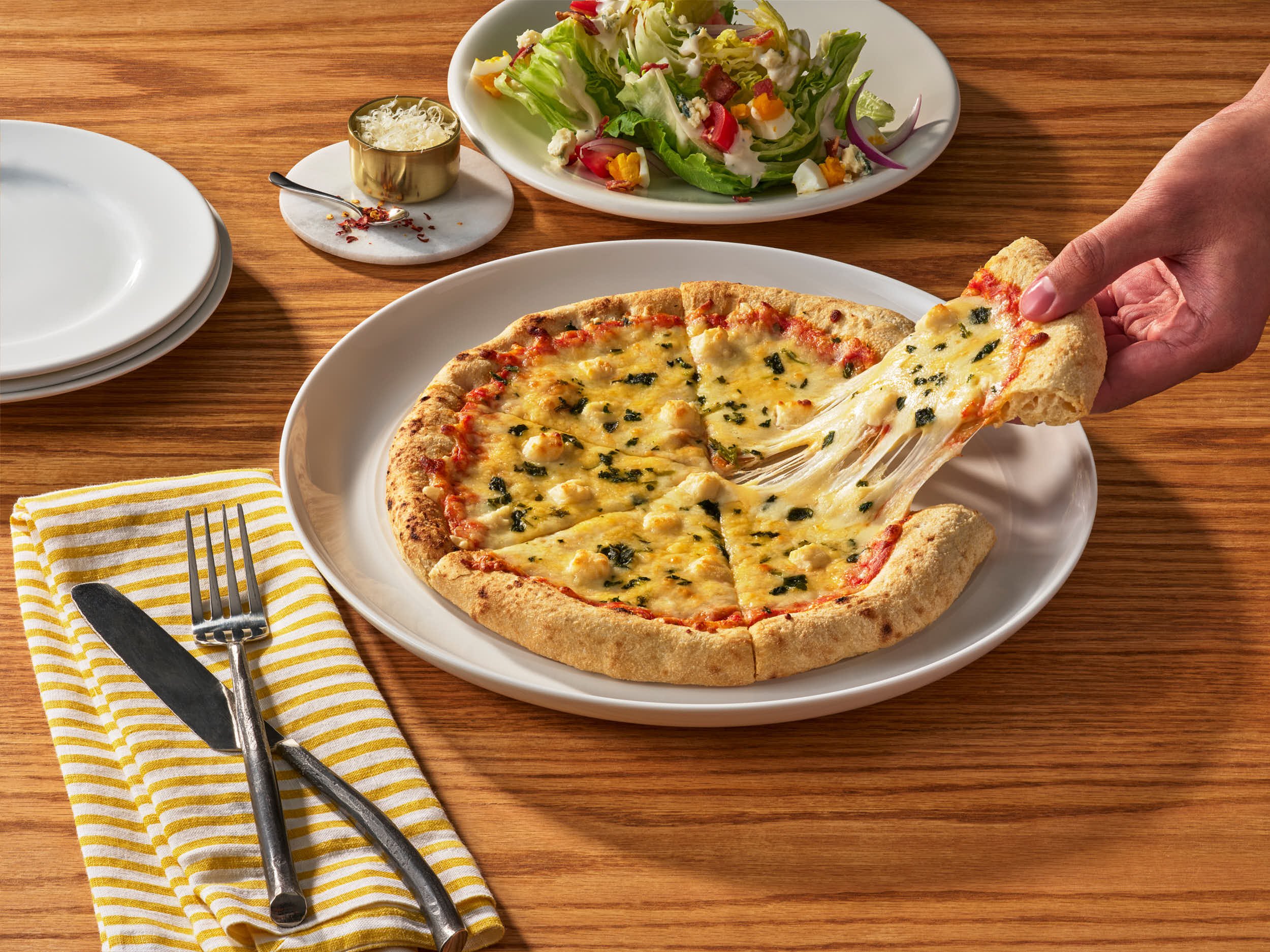 VisualAsset_CPK_NeapolitanCrust-SixCheese_Pizza_3-4_v2_lifestyle_241202.jpg
