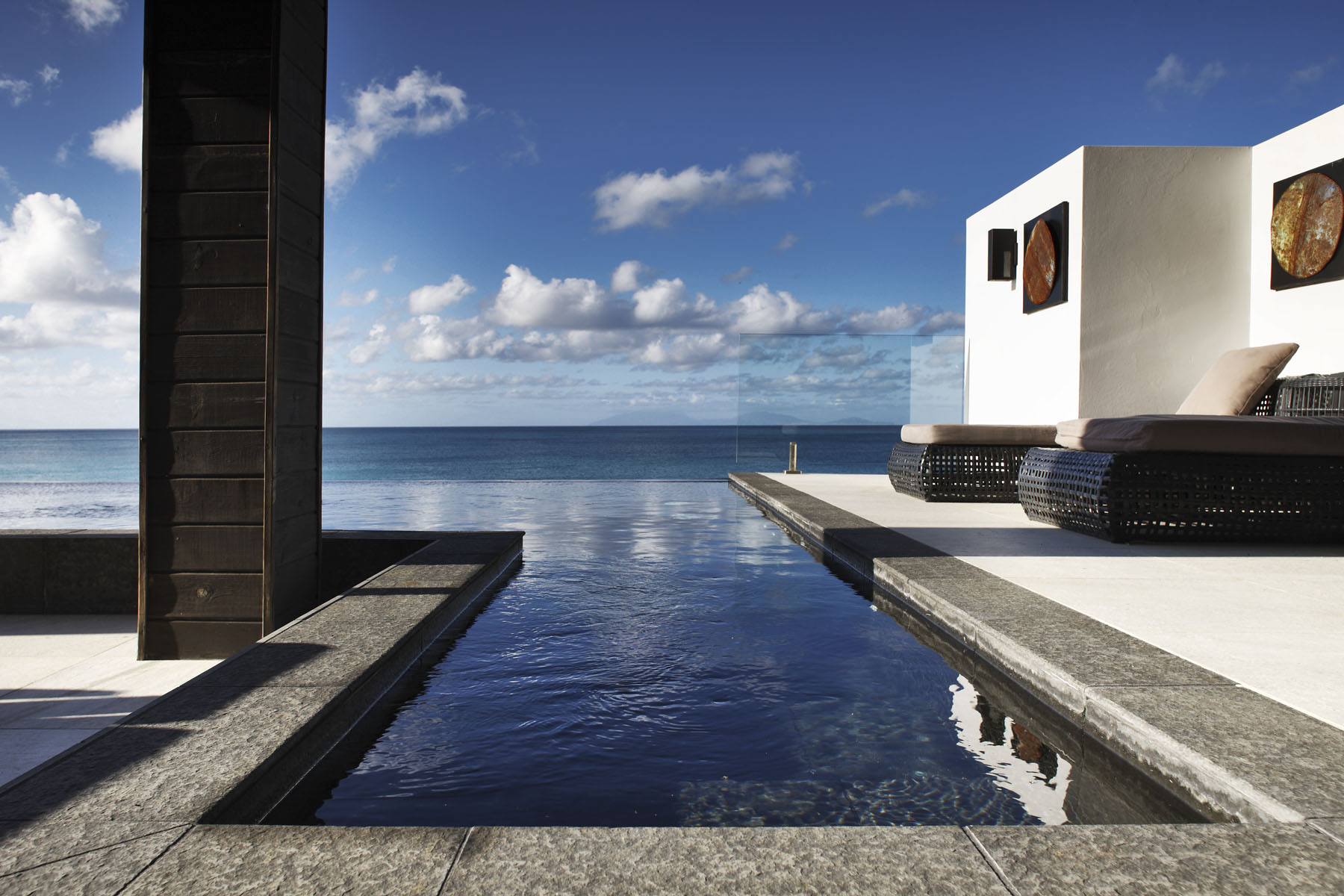 Step into the crystal Caribbean waters from your beachfront villa