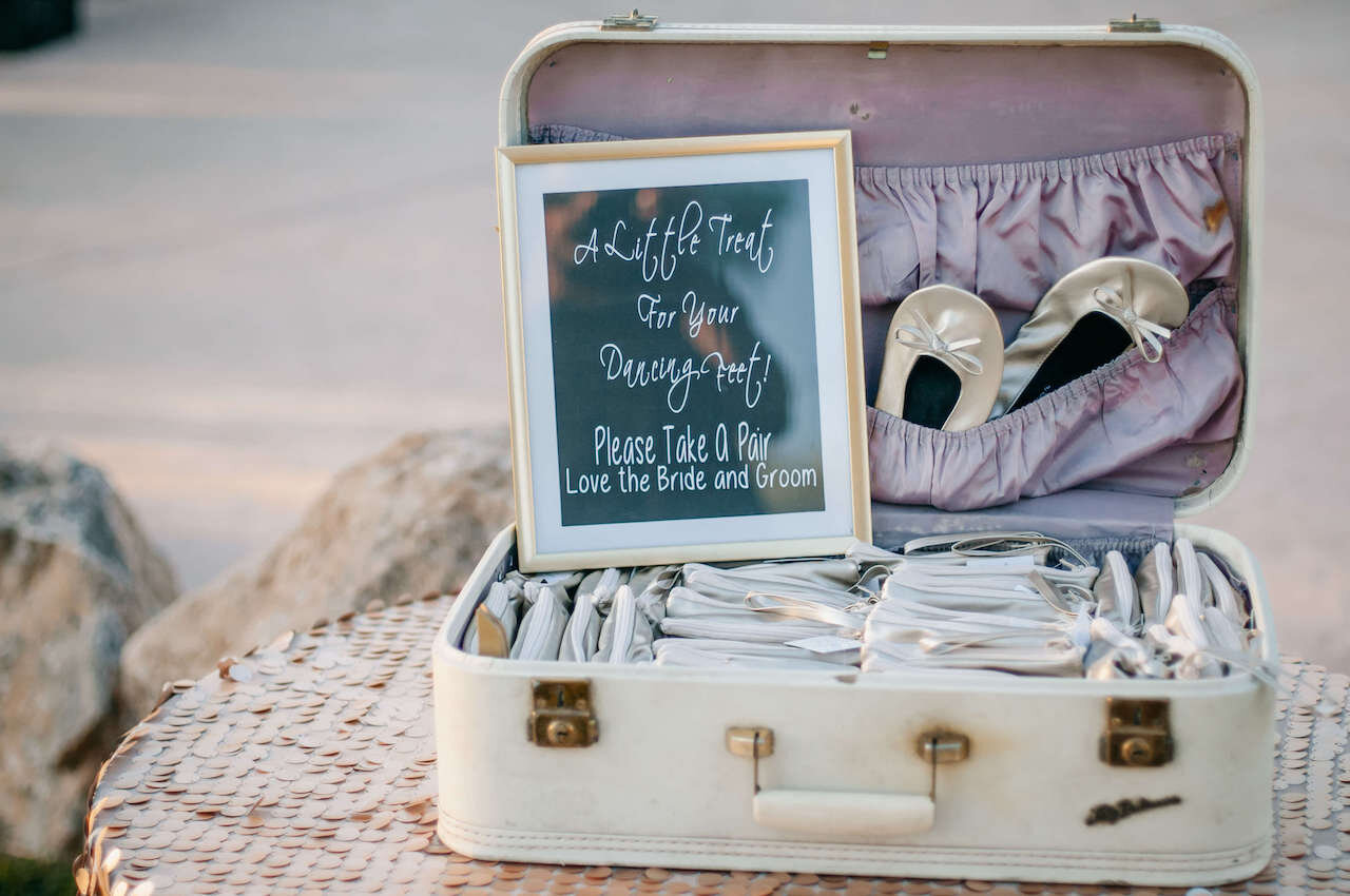 Old suitcase full of dancing shoes for guests for a fun wedding reception idea. 