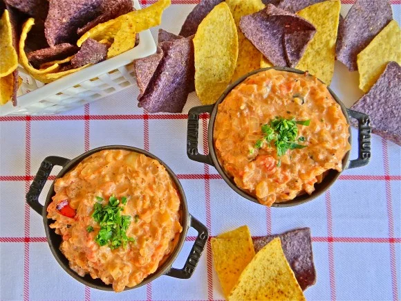 This sausage dip was inspired by my husband, Mike, who makes a version of this dish for every important football viewing event. He likes it because there are very few ingredients, it’s quick and easy to prepare, and it ALWAYS elicits great feedback. Make sure to cook the sausage until it is fully cooked through and well crumbled. Mike likes to serve his dip with Fritos Scoops, but you can select your choice of potato, corn or tortilla chip. Active Time: 30 minutes Makes about 4 cups Ingredients 2 hot Italian sausage links 2 tablespoons olive oil 1 large sweet onion, diced 1 teaspoon salt, divided 1 garlic clove, grated 14.5 oz can diced fire roasted tomatoes small pinch red pepper flakes 8 oz mascarpone cheese 2 tablespoons sour cream ¼ cup grated pecorino Preparation Remove the sausage meat from the casing. Heat a large non-stick skillet over medium-high heat and cook the sausage meat until browned and well-crumbled, 6 to 8 minutes. Transfer the sausage to bowl. Add the olive oil to the same pan. Turn the heat to medium and add the diced onion and ½ teaspoon of salt. Sauté until onions are soft and translucent, about 5 minutes. Add the garlic and cook for another minute or two. Return the sausage to the pan, along with the canned tomatoes, red pepper flakes mascarpone, sour cream, and pecorino. Stir to combine and cook for a minute or two to blend the flavors. Transfer the dip to a small fondue pot or little cast iron cauldron. Serve immediately with potato, corn or tortilla chips.