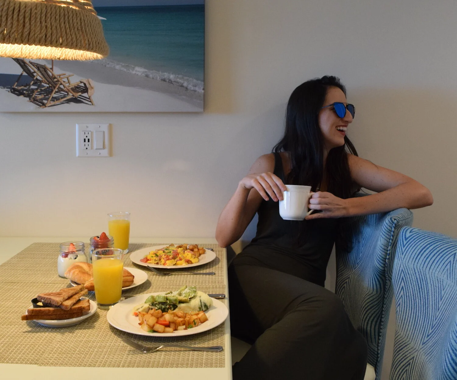Woman sitting in the dining section of one of our suites in Key West