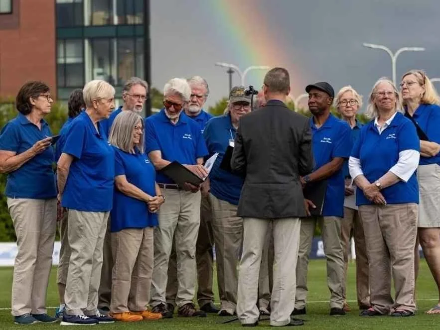 Chuck Taft and Asheville Senior Chorus preparing to perform the US National Anthem before a soccer match.