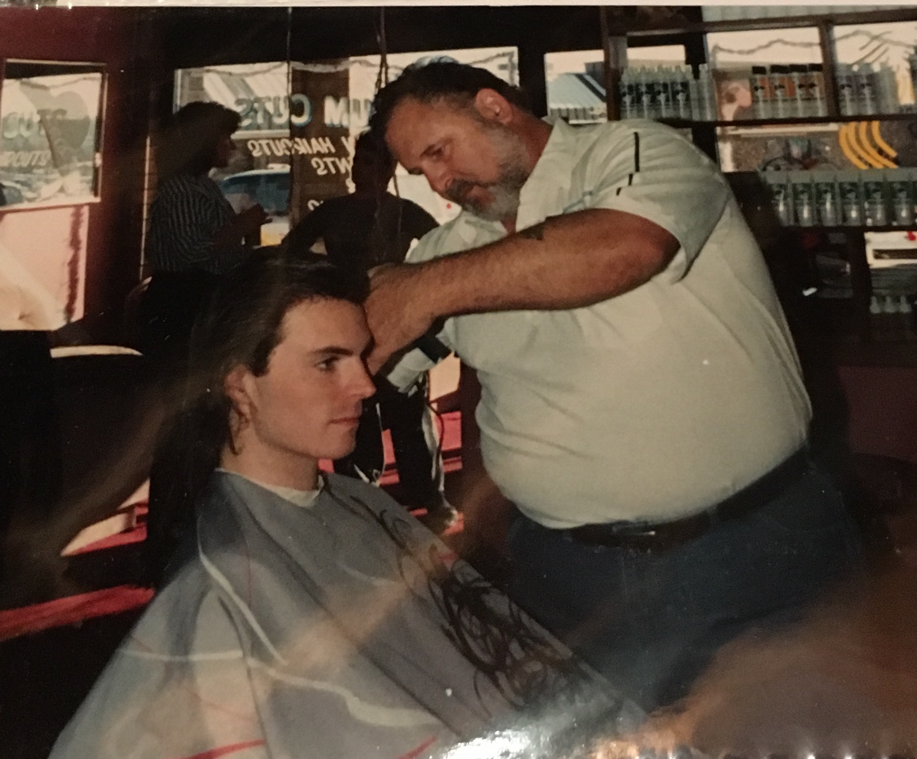 My pal Joe cutting my locks, ca. 1990. My Mama took the pic. This is my "I would prefer a beating" look.
