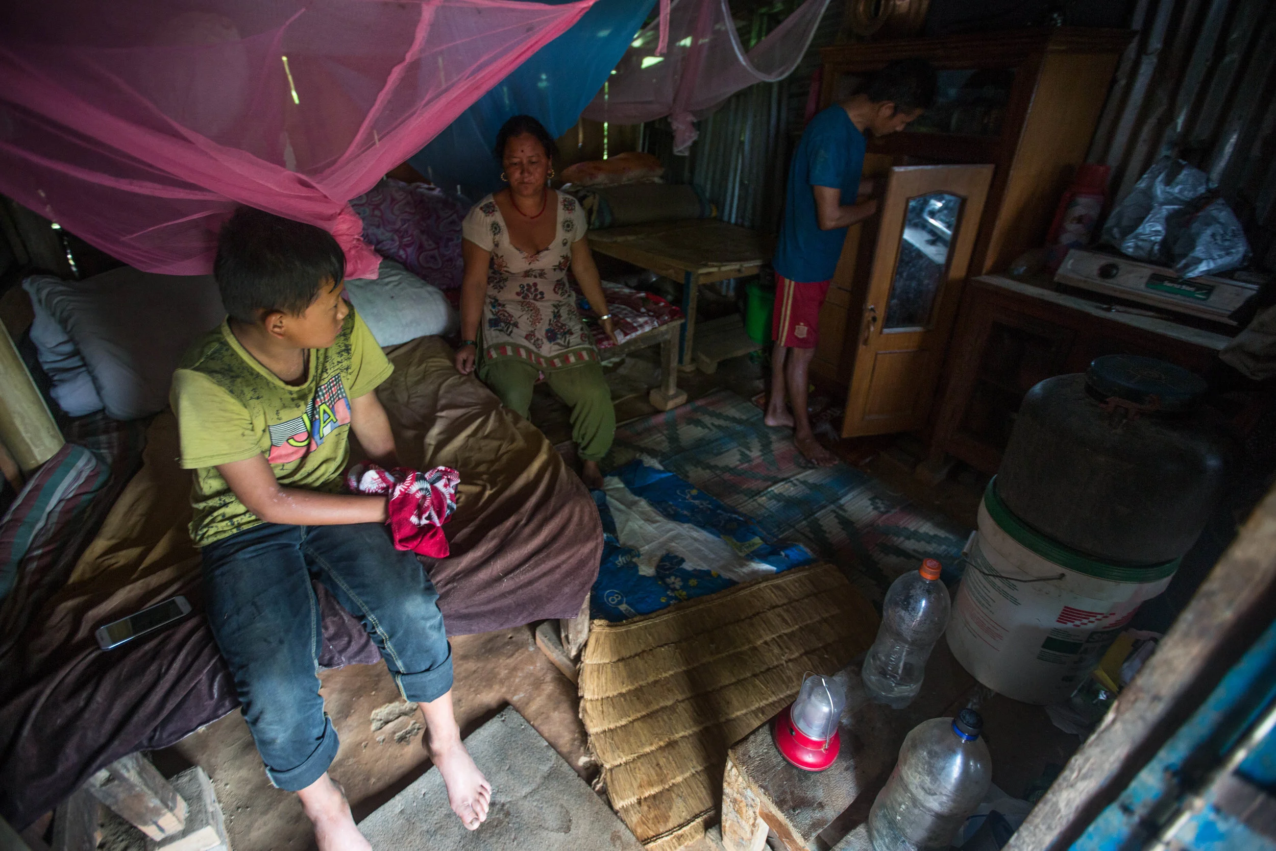 Sunil, Chari and Bhoj in their temporary home in Gorkha Nepal. Living near the earthquake's epicenter, they lost their home in 2015; they still await government assistance.