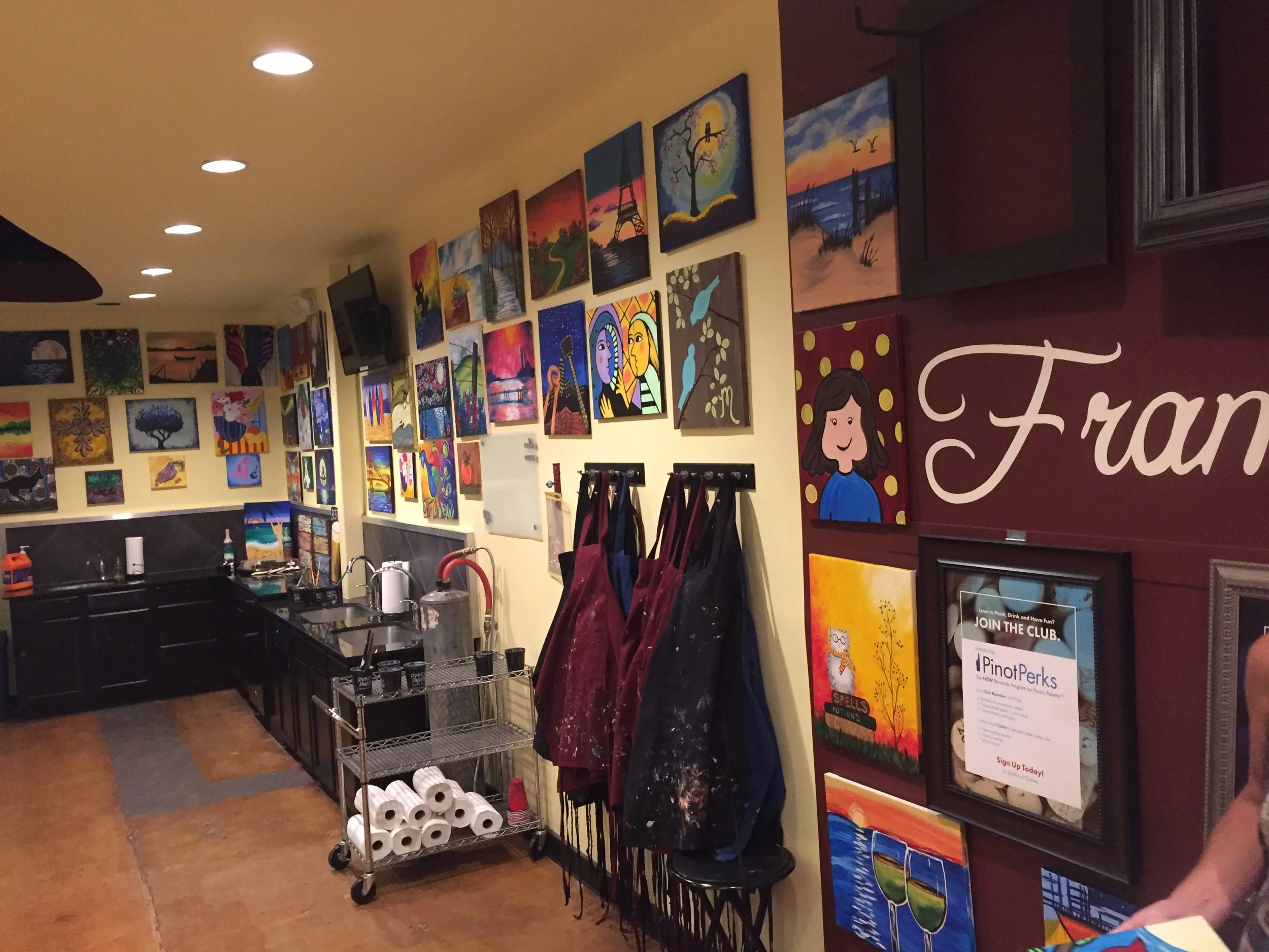 Inside Pinot's Palette, on the walls are a number of paintings you could choose to create. There is a clean up station in the back to wash your hands, and aprons on the wall to protect your clothes.