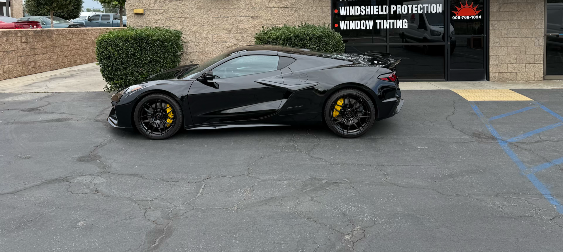 Black Chevrolet Corvette sports car parked  after autobahn incognito paint protection film installation