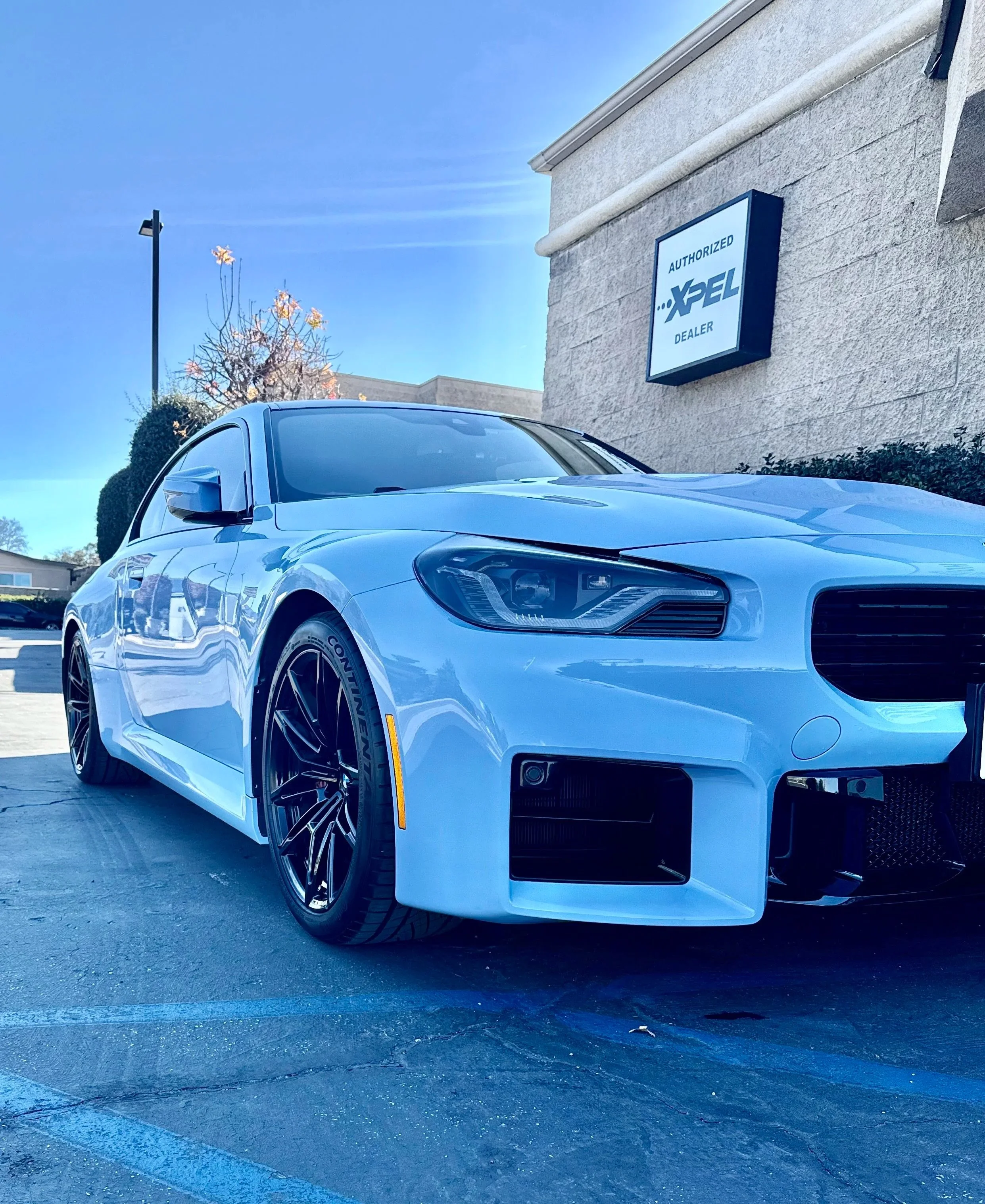 Close-up of the front part of a black pickup truck, showing the headlight and grille after ceramic coating by honest tint in Yucaipa ca. 