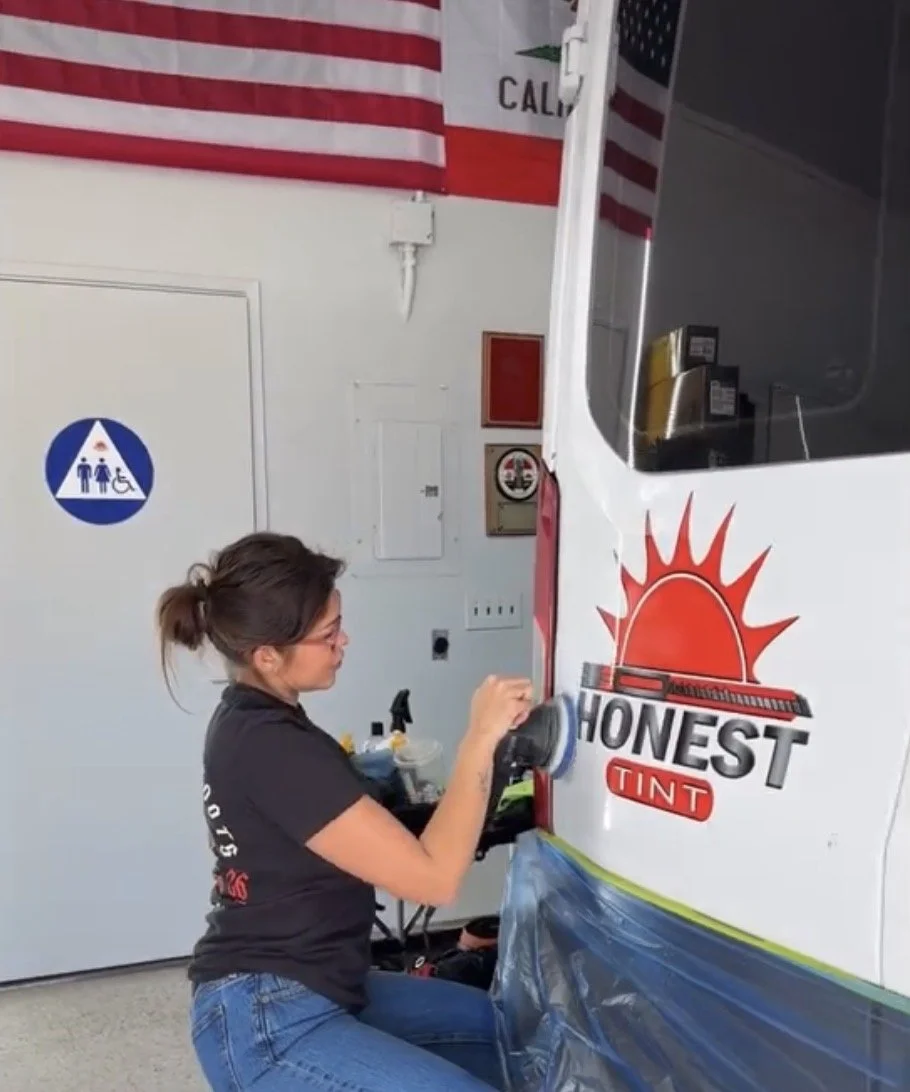 Liz paint correction and ceramic coating specialist performing paint correction on the Honest Tint mobile company vehicle servicing Yucaipa CA and surrounding cities.