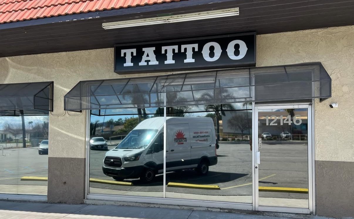 A storefront with a sign reading 'TATTOO' that has been tinted by honest tint & ppf in Yucaipa ca