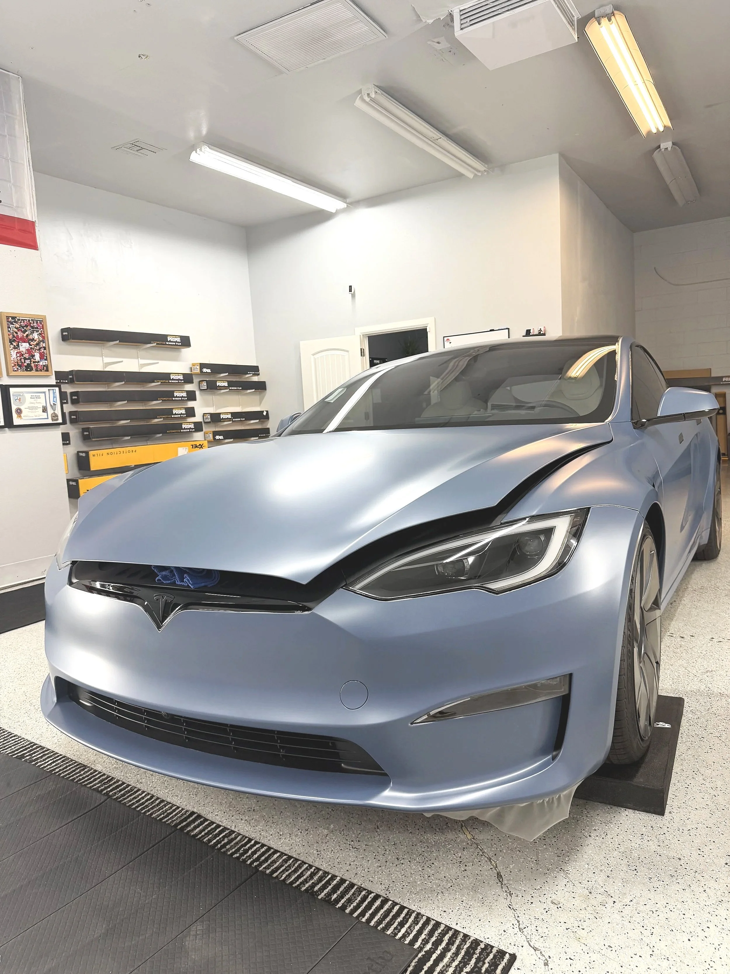 Close-up of the front of a red car with front-end installation of clear PPF installed by honest tint and ppf located in yucaipa ca. 