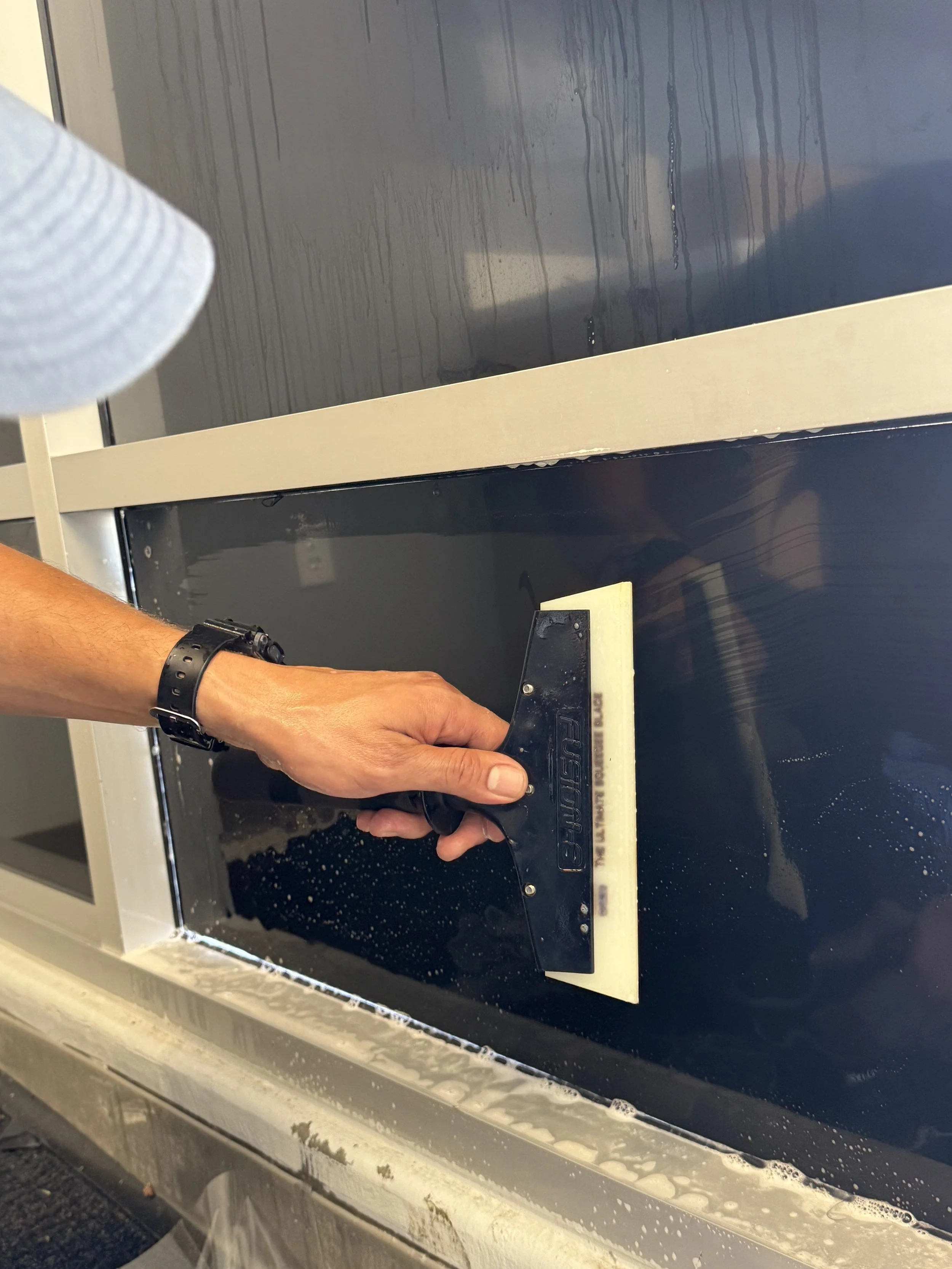 Danny installing black out film for bath and body works in Yucaipa ca shopping center