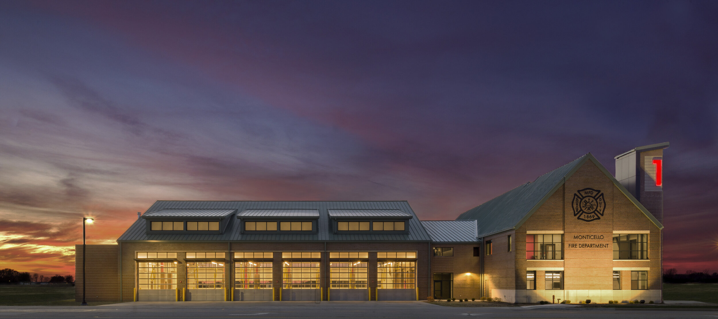 A stunning architectural photo of a fire department building at twilight.