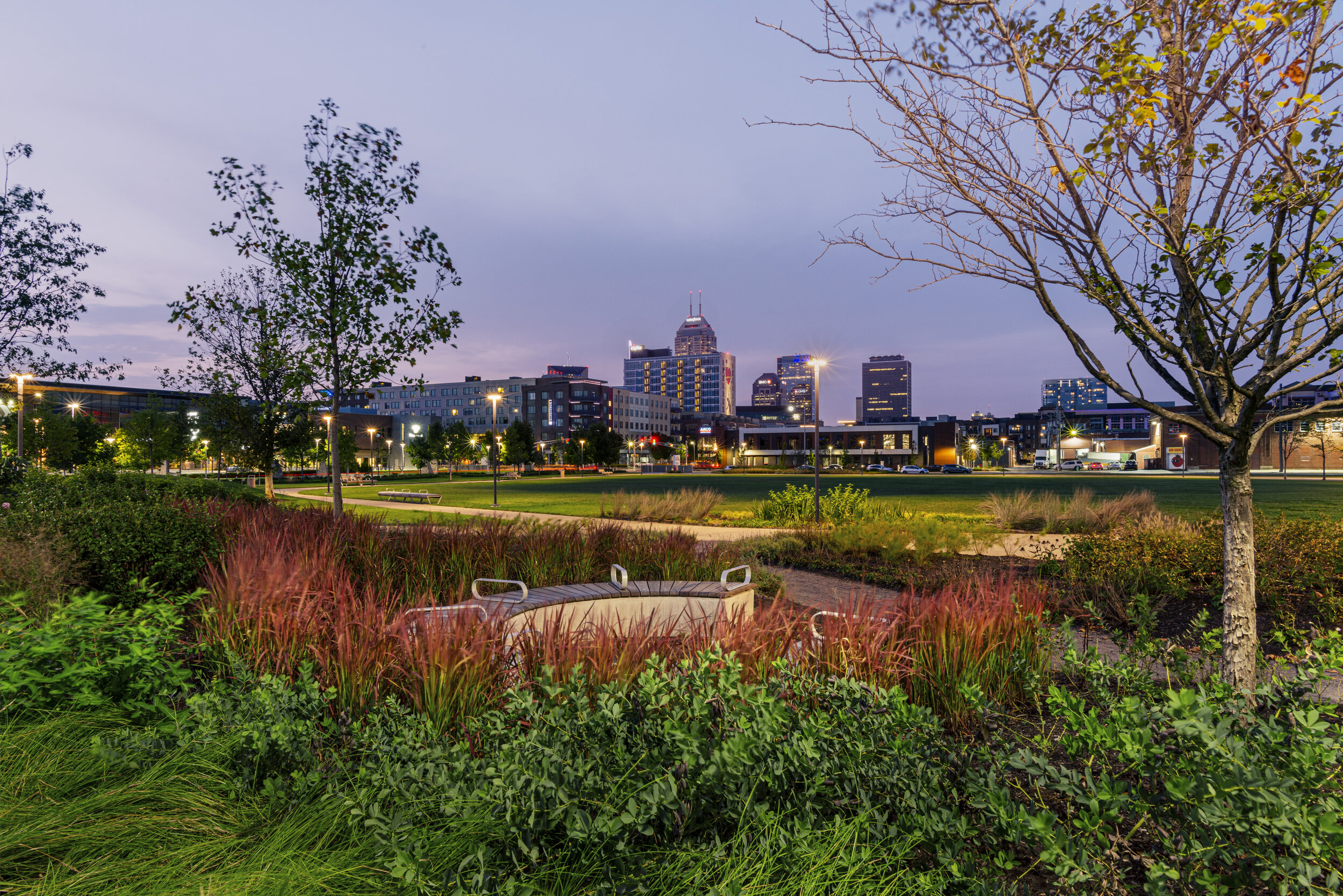 Photography showing a park at twilight with view to the city of Indianapolis.